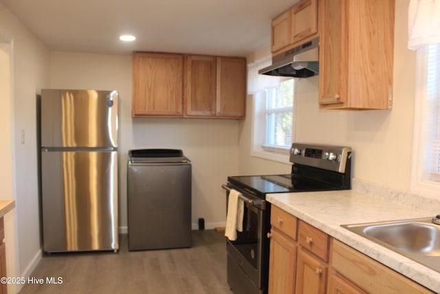 kitchen featuring under cabinet range hood, baseboards, light countertops, and appliances with stainless steel finishes