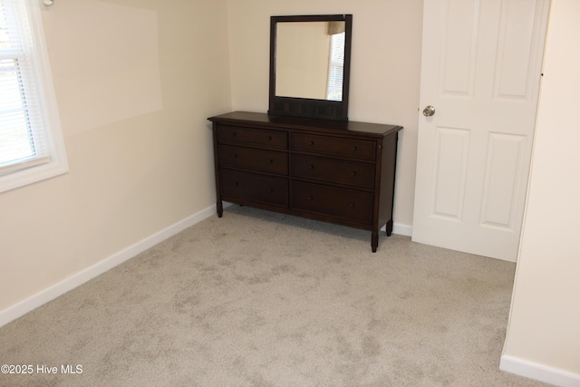 bedroom featuring light carpet