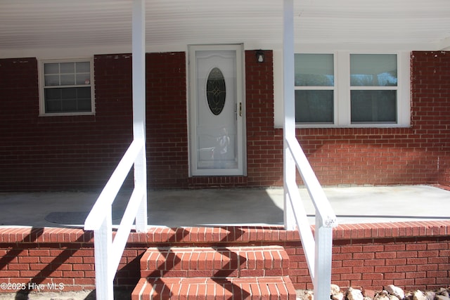 view of exterior entry featuring a porch