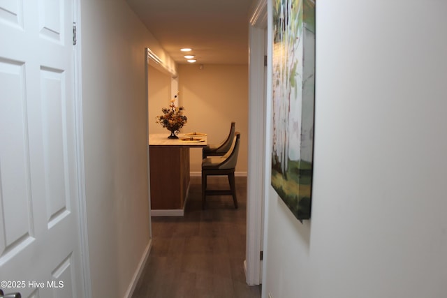 hallway with dark hardwood / wood-style flooring