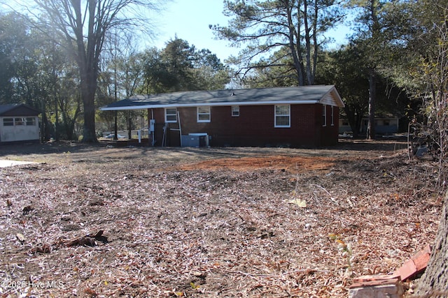 back of property with brick siding and cooling unit