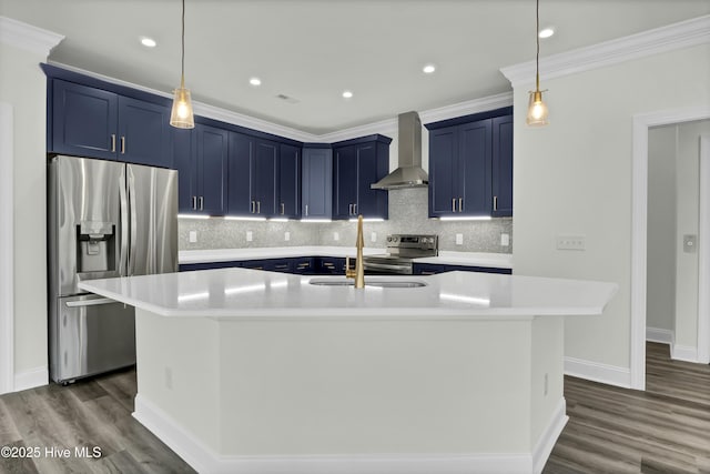 kitchen with wall chimney exhaust hood, stainless steel appliances, blue cabinets, and light countertops