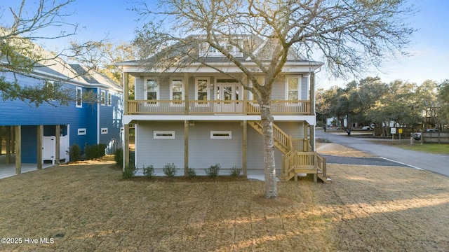 exterior space featuring a front lawn and stairs