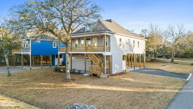 view of front facade featuring stairway, a carport, and gravel driveway