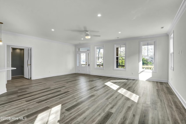 unfurnished living room with crown molding, wood finished floors, and a healthy amount of sunlight