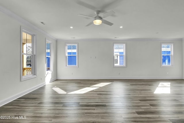 unfurnished room featuring visible vents, baseboards, ornamental molding, recessed lighting, and wood finished floors