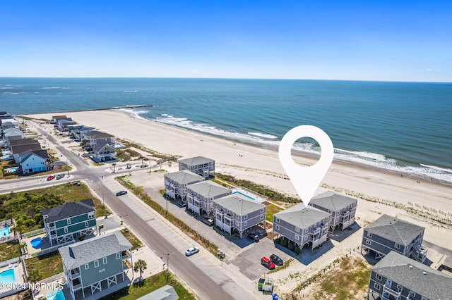 bird's eye view featuring a view of the beach and a water view