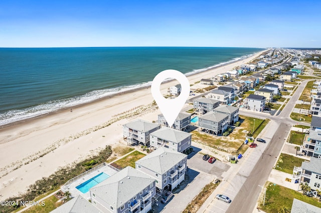 aerial view featuring a water view and a beach view