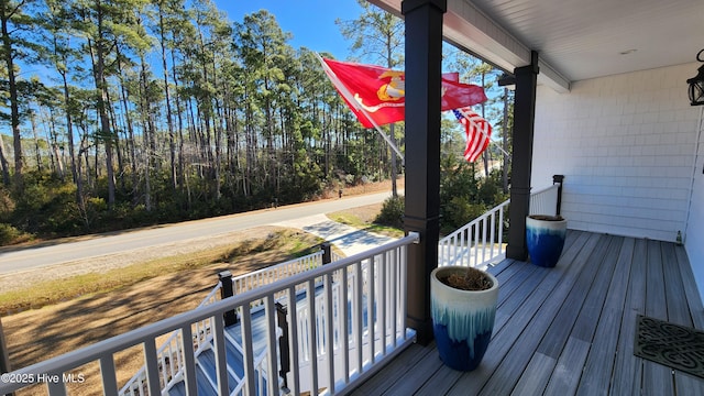 wooden terrace featuring covered porch