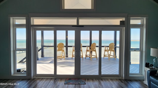 doorway to outside with hardwood / wood-style floors and a water view