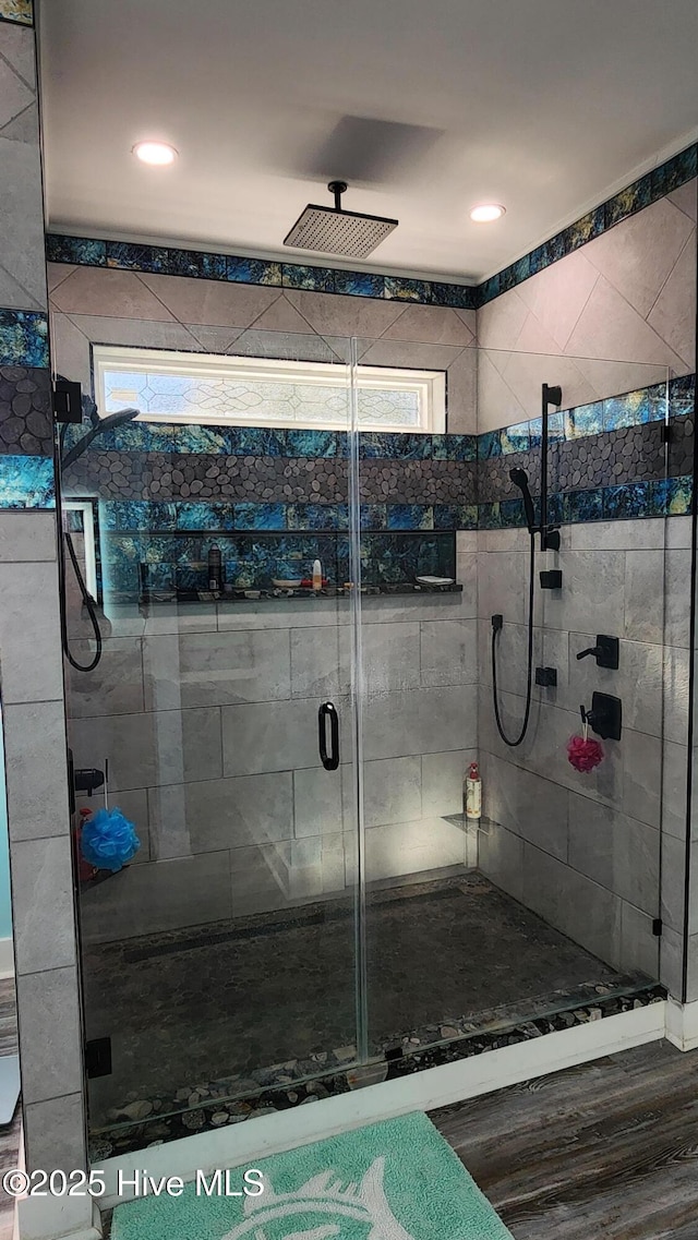 bathroom with walk in shower, wood-type flooring, and a wealth of natural light