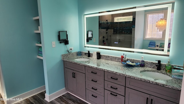 bathroom with walk in shower, vanity, and wood-type flooring