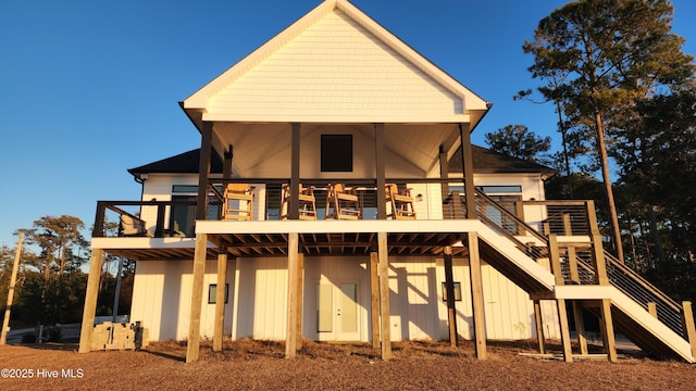 rear view of property featuring a wooden deck