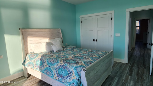 bedroom featuring dark hardwood / wood-style floors and a closet