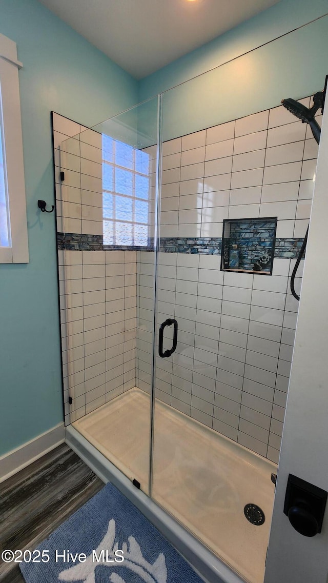 bathroom featuring hardwood / wood-style flooring and walk in shower