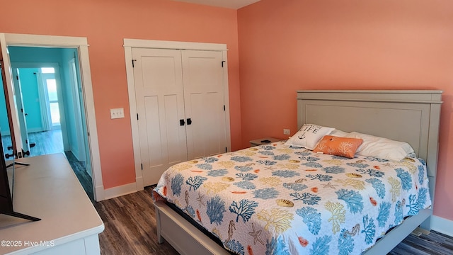 bedroom with a closet and dark hardwood / wood-style floors