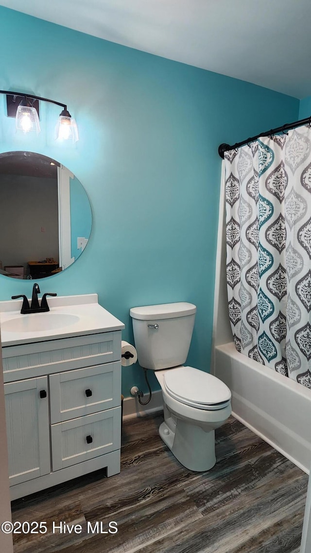 full bathroom with vanity, hardwood / wood-style floors, shower / tub combo, and toilet