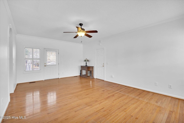 empty room featuring crown molding, ceiling fan, a textured ceiling, and light hardwood / wood-style floors