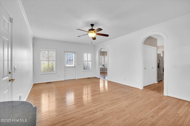 living room featuring ornamental molding, ceiling fan, a textured ceiling, and light hardwood / wood-style floors