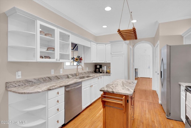 kitchen featuring white cabinetry, stainless steel appliances, light stone countertops, and sink