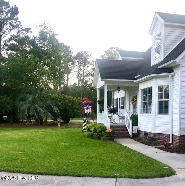 exterior space featuring a yard and covered porch