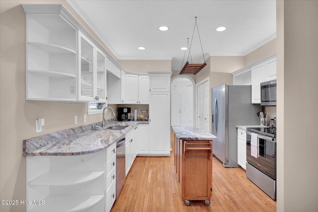 kitchen with stainless steel appliances, white cabinetry, and sink