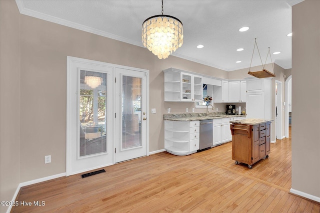 kitchen with light stone counters, hanging light fixtures, stainless steel dishwasher, a kitchen island, and white cabinets