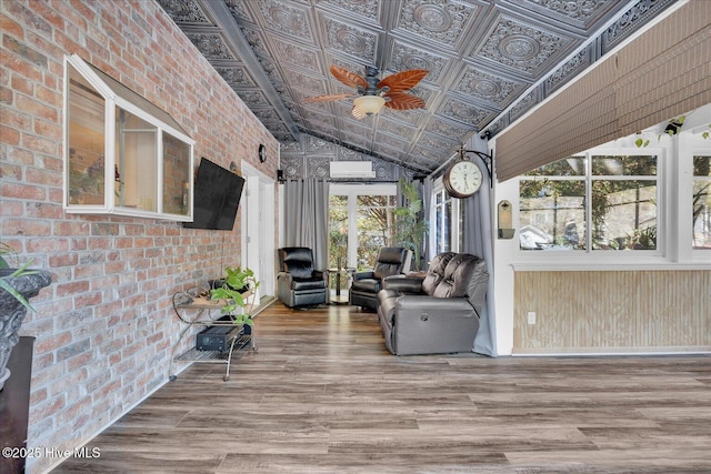 sunroom featuring vaulted ceiling and ceiling fan