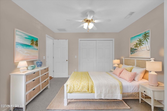 carpeted bedroom featuring ceiling fan and a closet