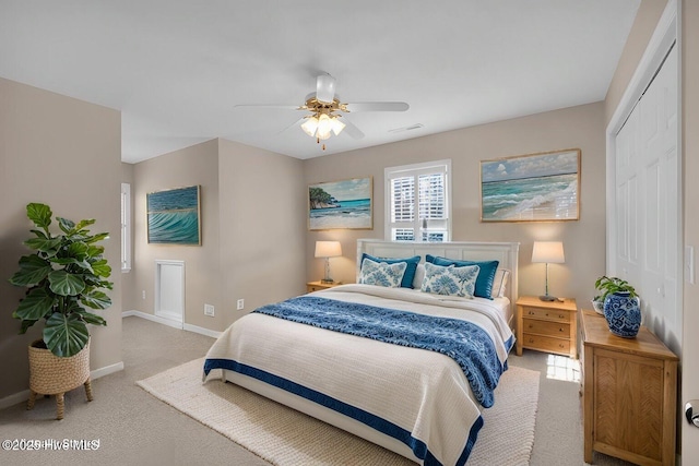 bedroom featuring light colored carpet, a closet, and ceiling fan