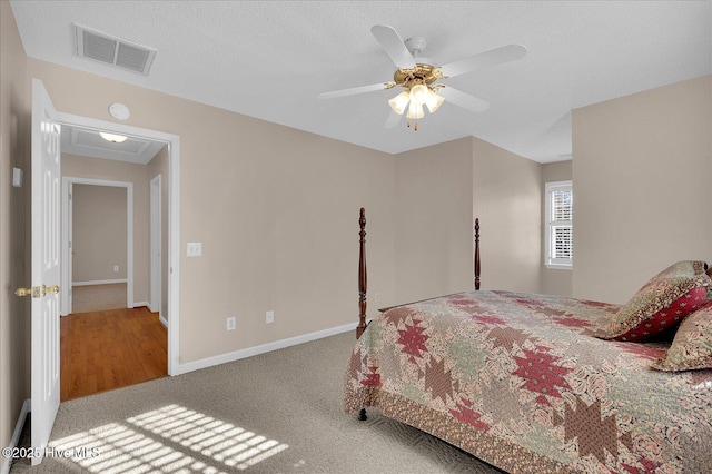 carpeted bedroom with ceiling fan and a textured ceiling