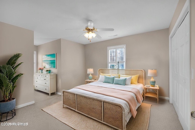 carpeted bedroom featuring ceiling fan and a closet