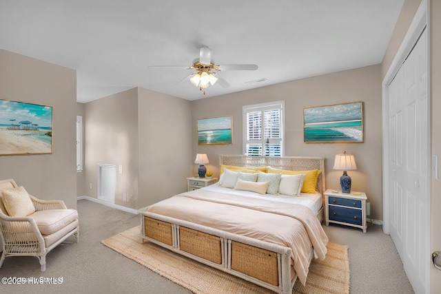 carpeted bedroom with ceiling fan and a closet