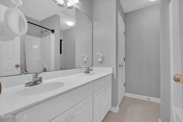 bathroom with vanity and a shower