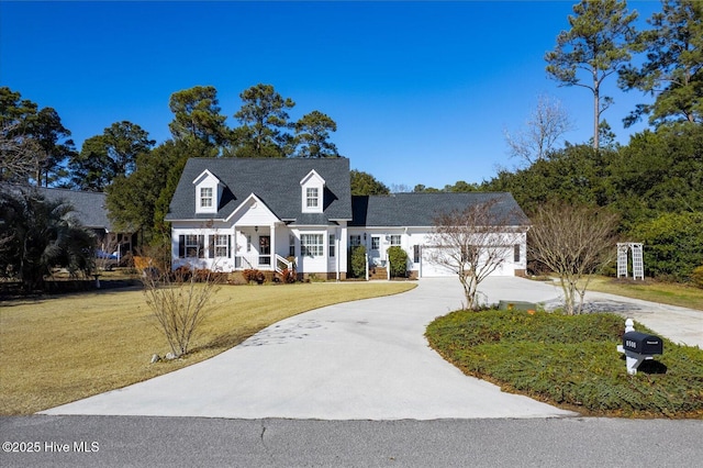 cape cod home with a garage and a front lawn