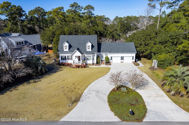 new england style home featuring a garage and a front yard