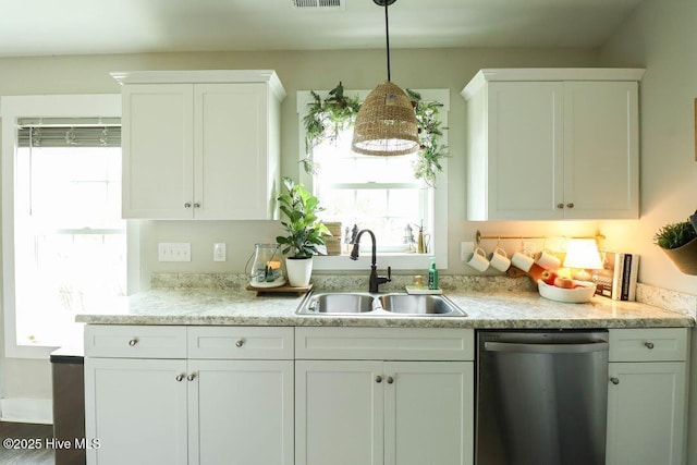 kitchen with white cabinetry, sink, hanging light fixtures, and dishwasher