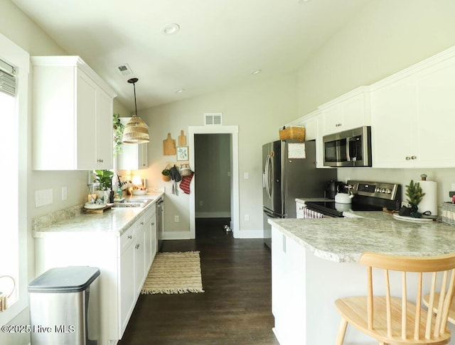 kitchen with sink, white cabinets, hanging light fixtures, kitchen peninsula, and stainless steel appliances