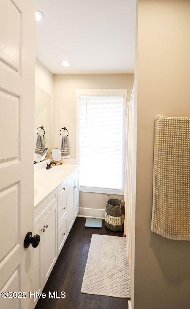 bathroom featuring vanity and hardwood / wood-style flooring