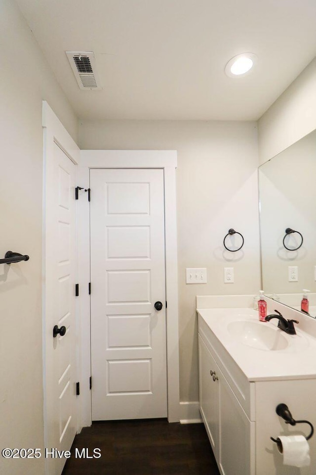 bathroom with vanity and hardwood / wood-style flooring