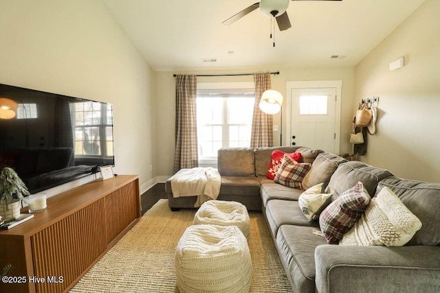 living room featuring lofted ceiling, light wood-type flooring, and ceiling fan