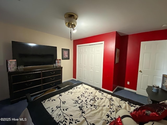 bedroom featuring dark colored carpet and a closet