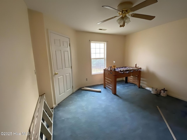 office with ceiling fan and dark carpet