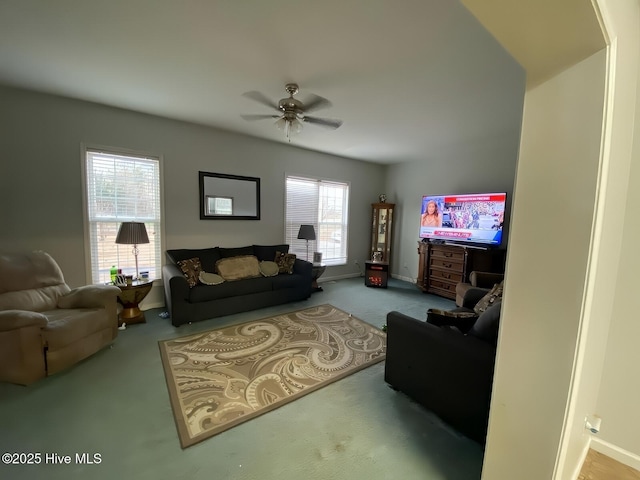 living room featuring ceiling fan and carpet