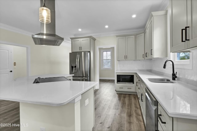 kitchen featuring ornamental molding, decorative backsplash, stainless steel appliances, wall chimney exhaust hood, and a sink