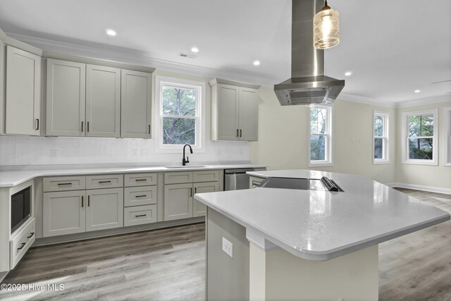 kitchen featuring a kitchen island, island exhaust hood, a sink, stainless steel dishwasher, and crown molding