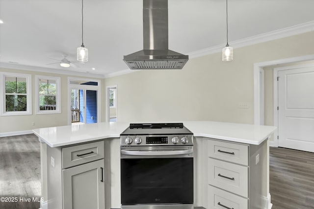 kitchen with electric range, gray cabinets, wall chimney exhaust hood, crown molding, and light countertops