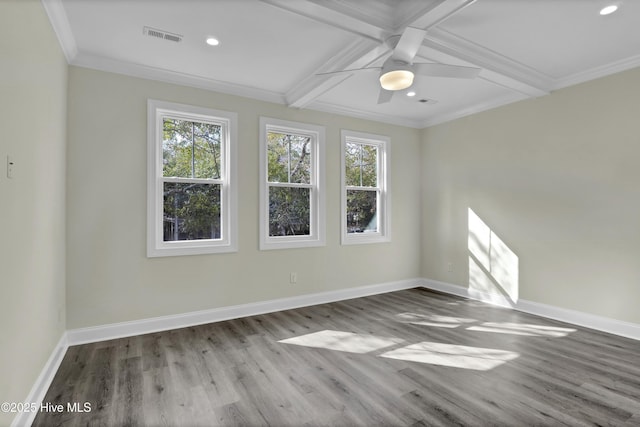 unfurnished room with baseboards, plenty of natural light, visible vents, and wood finished floors