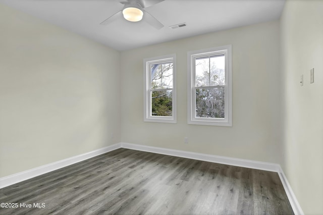 unfurnished room featuring ceiling fan, visible vents, baseboards, and wood finished floors