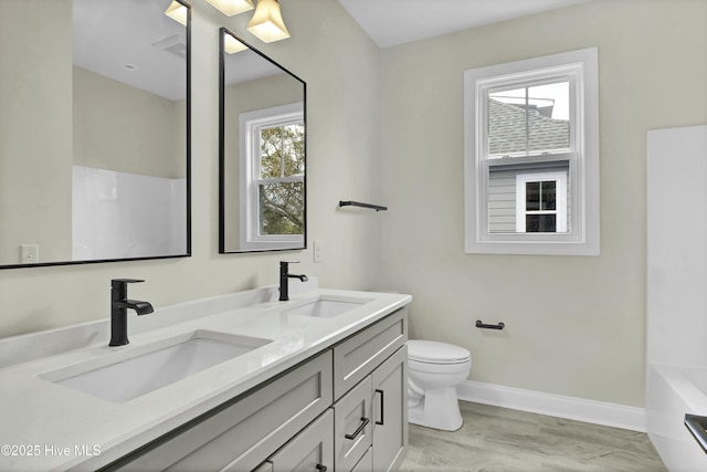 full bathroom featuring a sink, baseboards, a bathing tub, and toilet